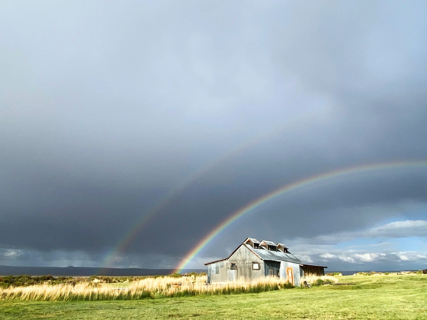 Double rainbow over the Summer Lake Hot Springs bathhouse