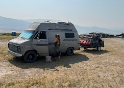 Van and camper parked on the Summer Lake Hot Springs property, Oregon desert backdrop